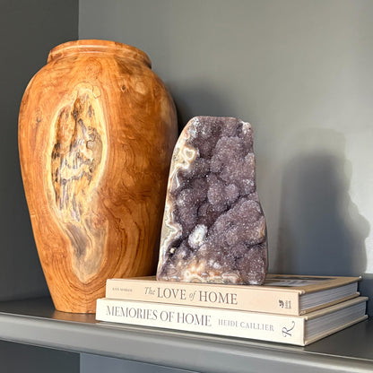 Rainbow amethyst geode decor on living room bookshelf