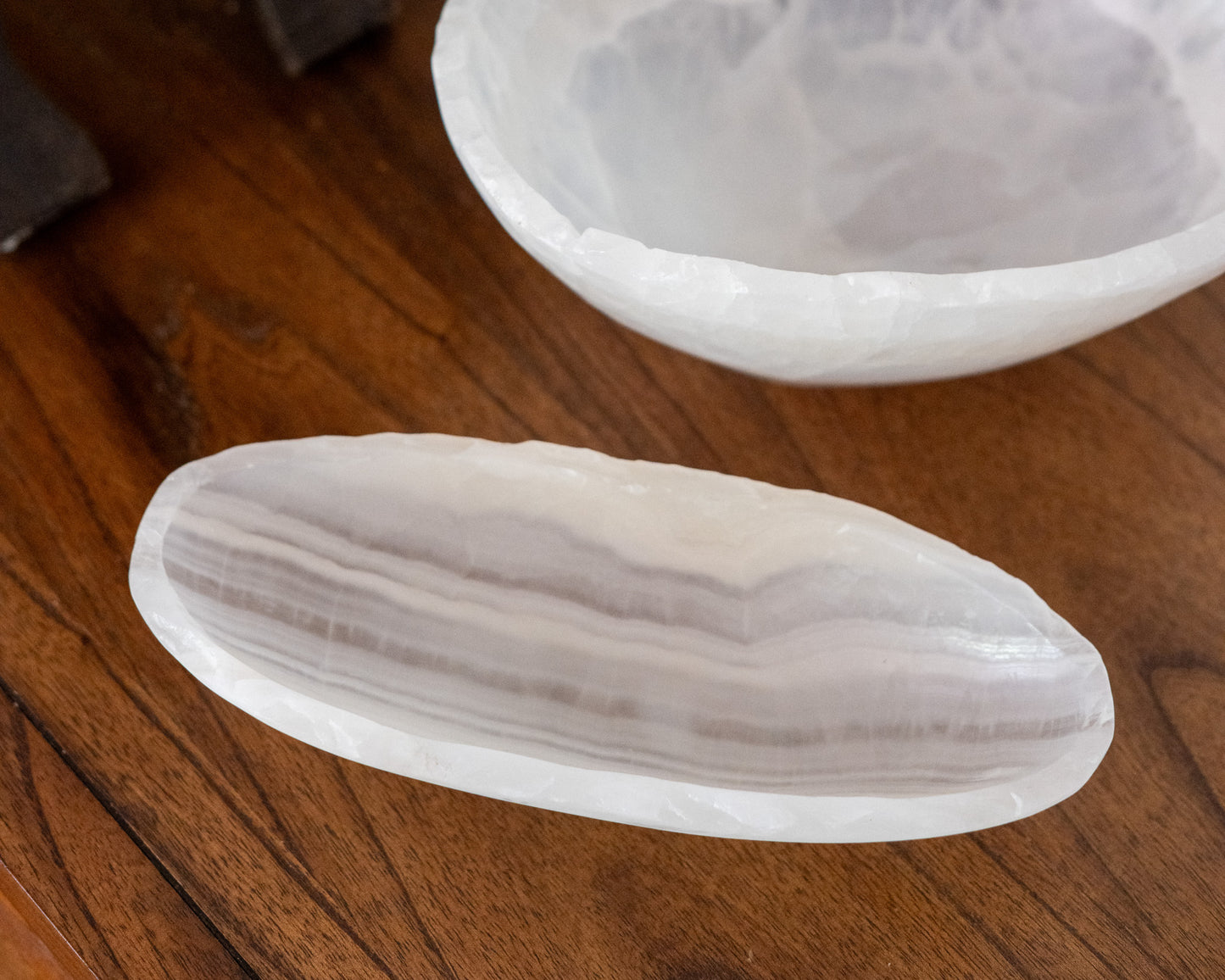 Decorative white onyx canoe bowl with organic veining and smooth finish