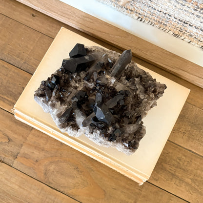 Raw smoky quartz crystal cluster mineral specimen used for spiritual and boho home decor.