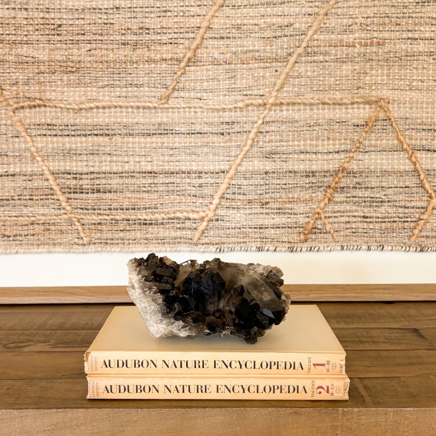 Smoky quartz crystal cluster displayed as elegant luxury home decor with natural mineral texture and deep translucent brown tones.