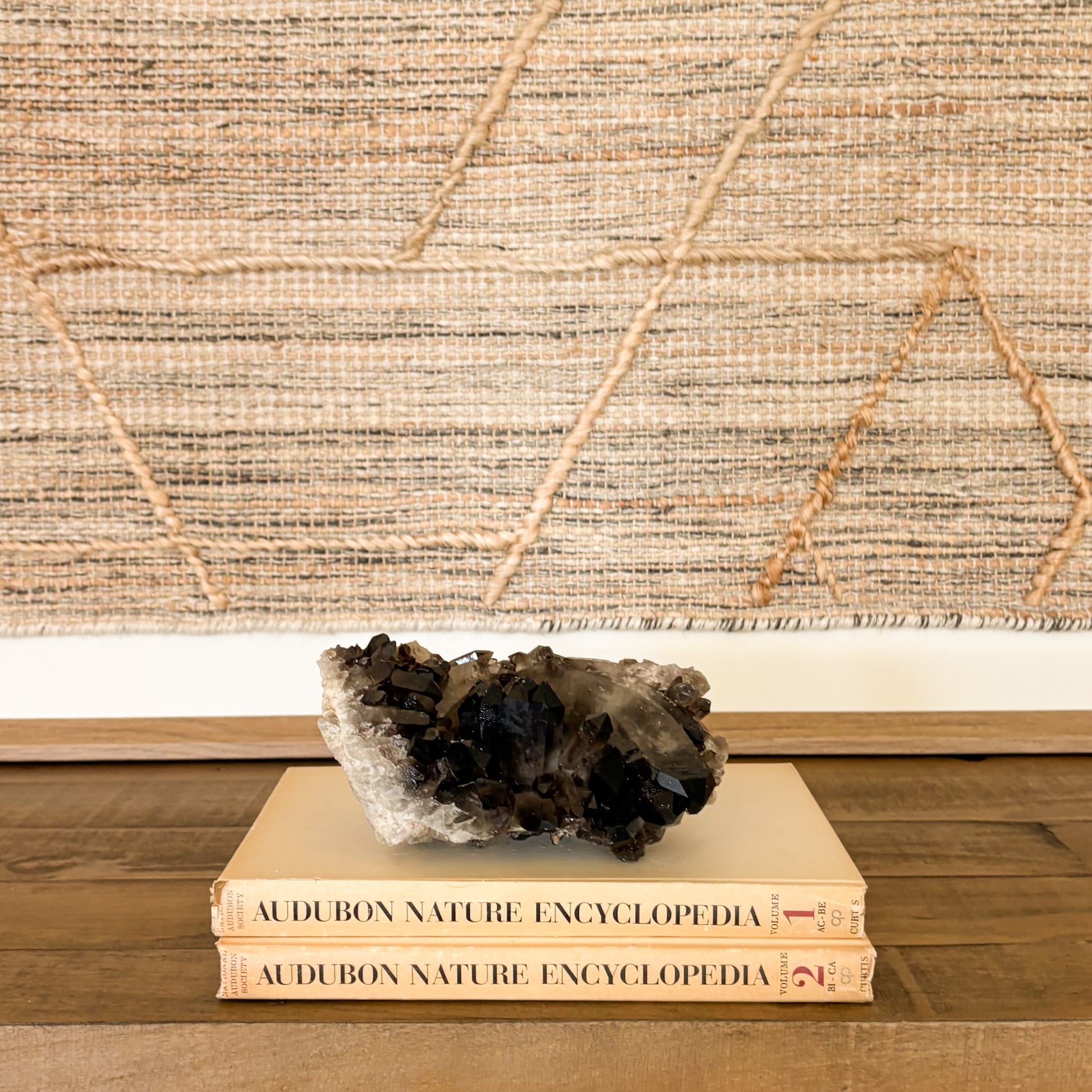 Smoky quartz crystal cluster displayed as elegant luxury home decor with natural mineral texture and deep translucent brown tones.