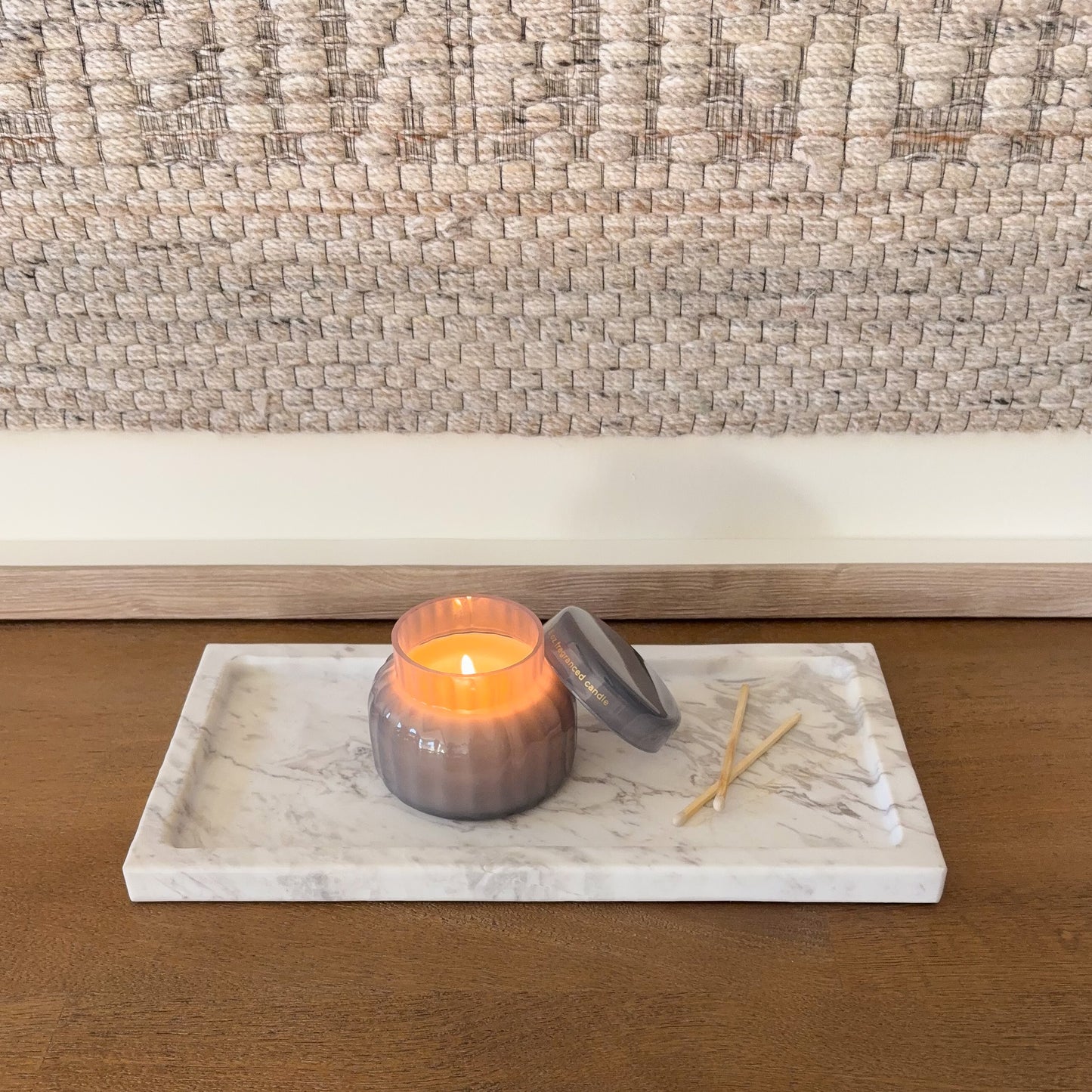 Rectangular Greek marble tray with natural grey veining and lit candle
