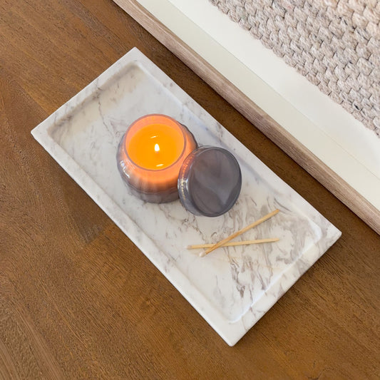 White Volakas marble decorative tray styled with glass candle jar