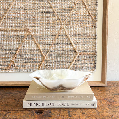 Hand-carved white onyx decorative bowl styled on coffee table with neutral home decor