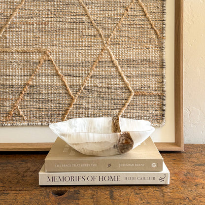 White onyx bowl styled on coffee table with design books luxury home decor