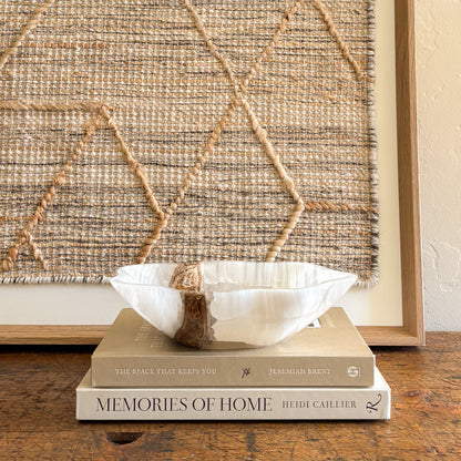 Hand-carved white onyx bowl styled with interior design books luxury decor