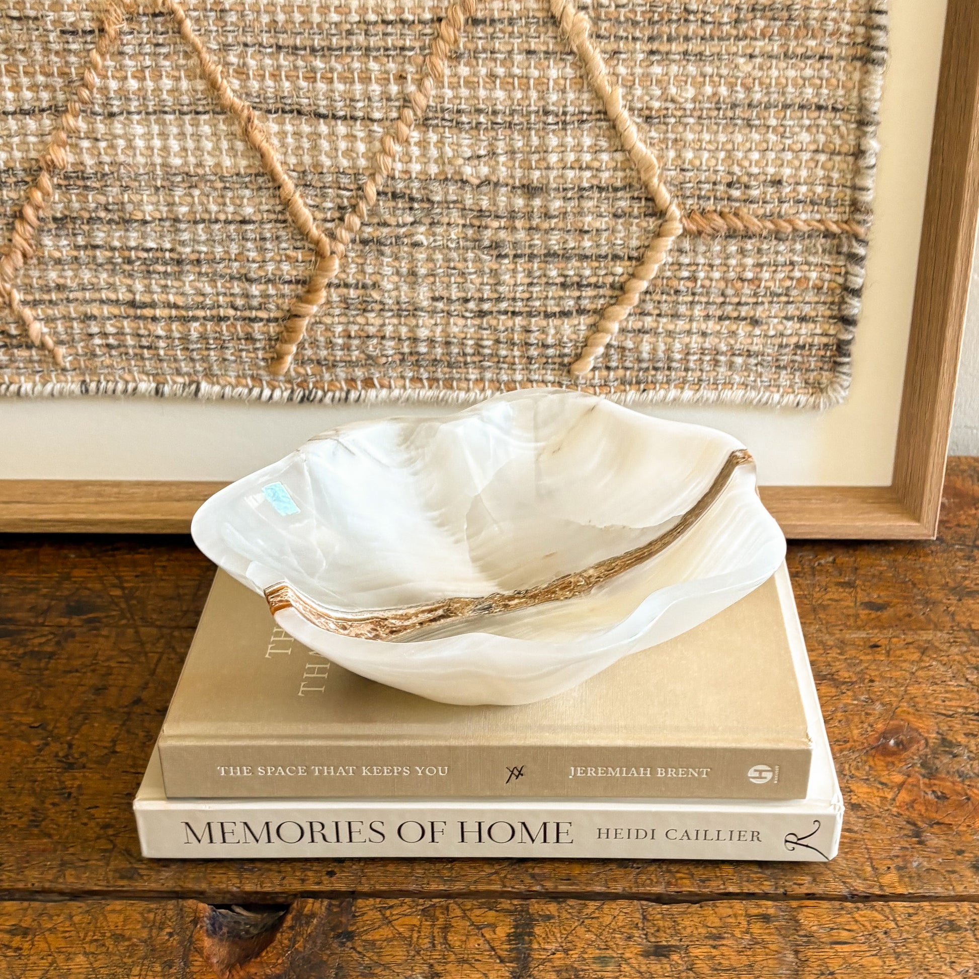 White onyx bowl styled on coffee table with design books luxury home decor