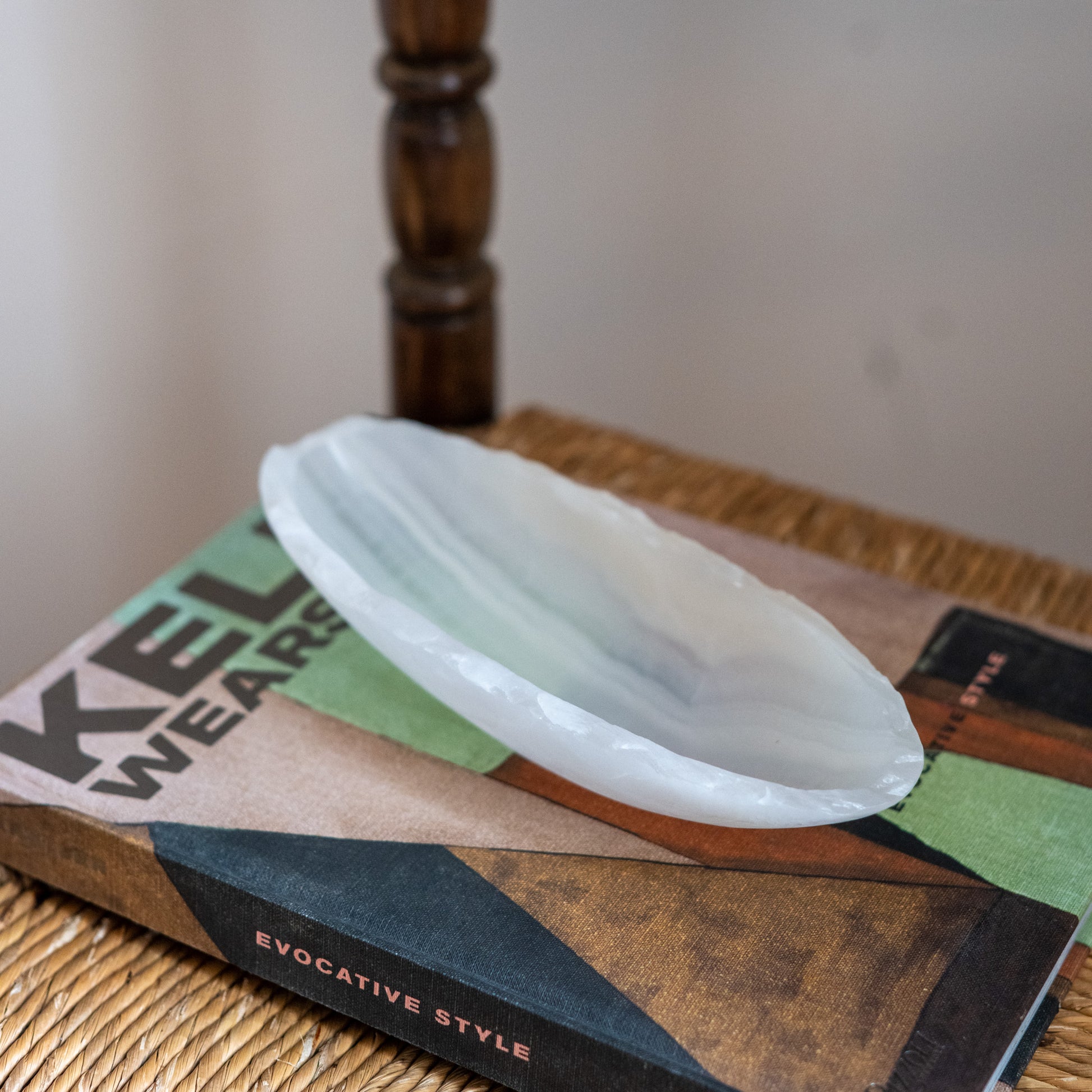 Minimalist white onyx canoe tray styled on designer interior décor book