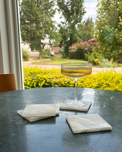 Elegant white onyx coaster set with polished natural stone finish and unique variations