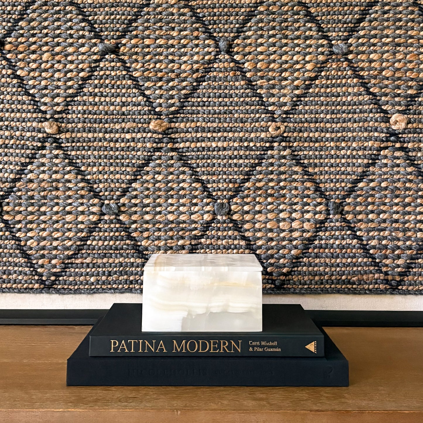 Handcrafted white onyx stone box closed on stacked books