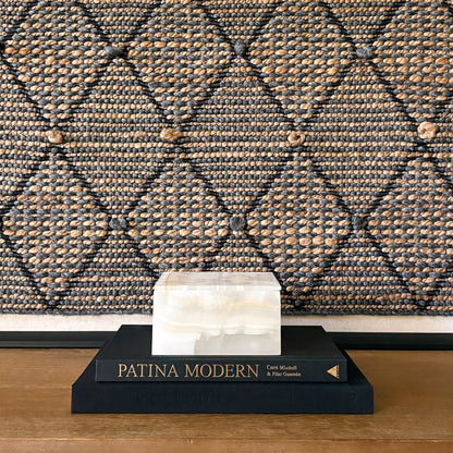 Square white onyx storage box displayed on coffee table books