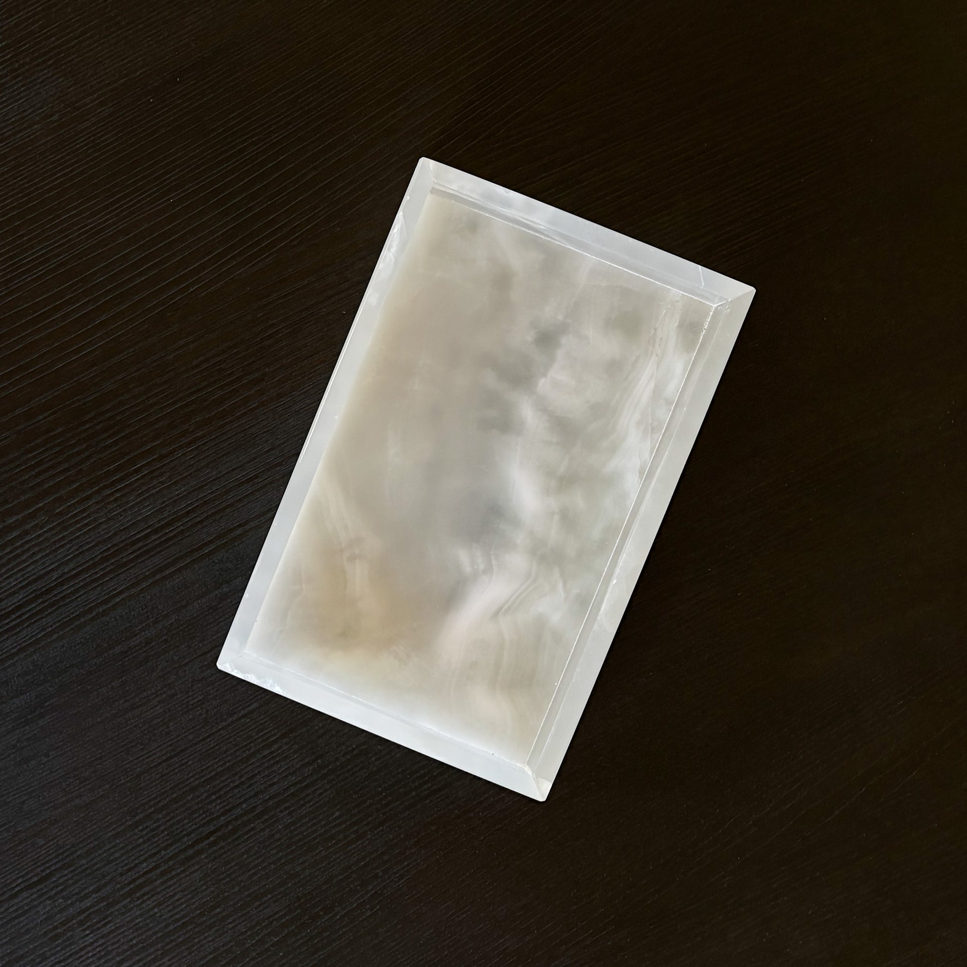 white stone tray with natural veining styled in minimalist living room setting