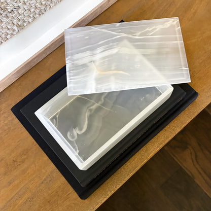 Luxury rectangular white onyx jewelry box displayed on modern console table with neutral home decor