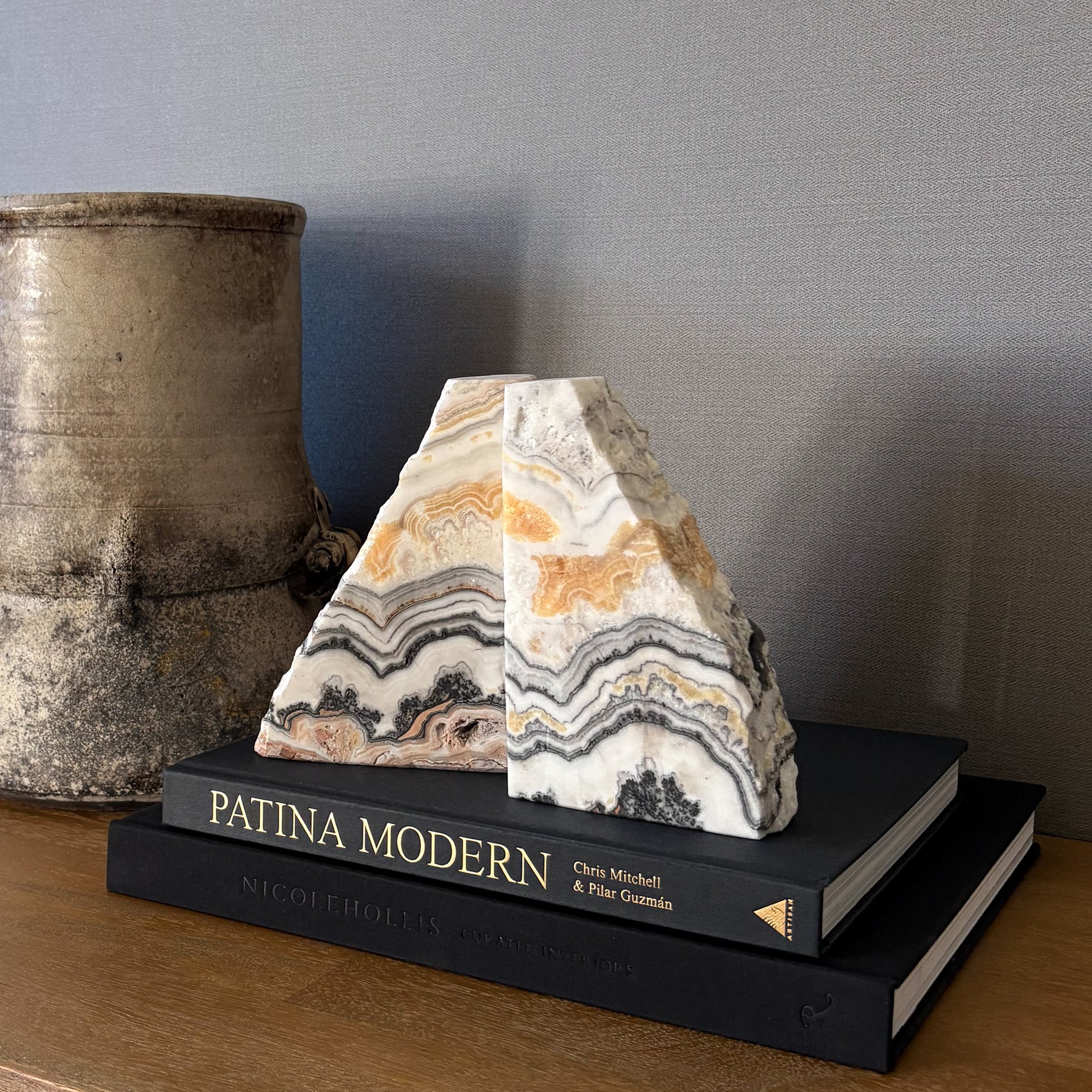Organic modern zebra calcite bookends on stacked design books