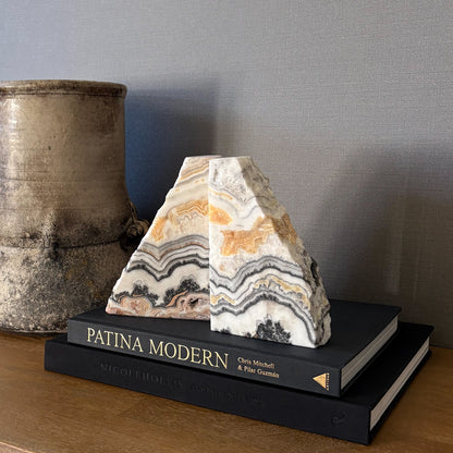 Organic modern zebra calcite bookends on stacked design books
