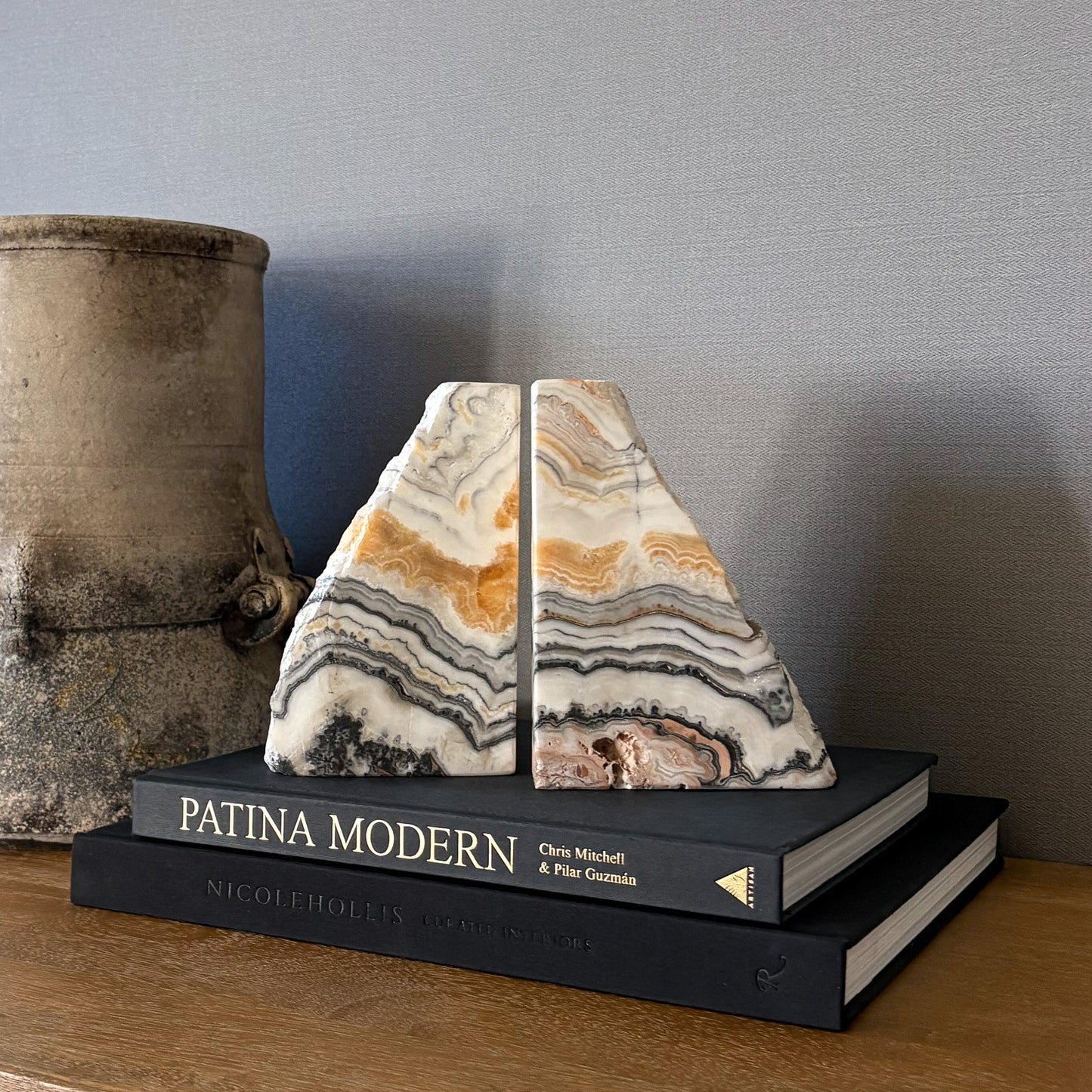 Cream and honey zebra calcite bookend set styled on wooden console table
