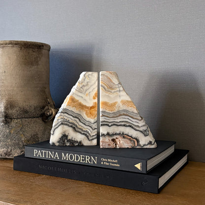 Cream and honey zebra calcite bookend set styled on wooden console table