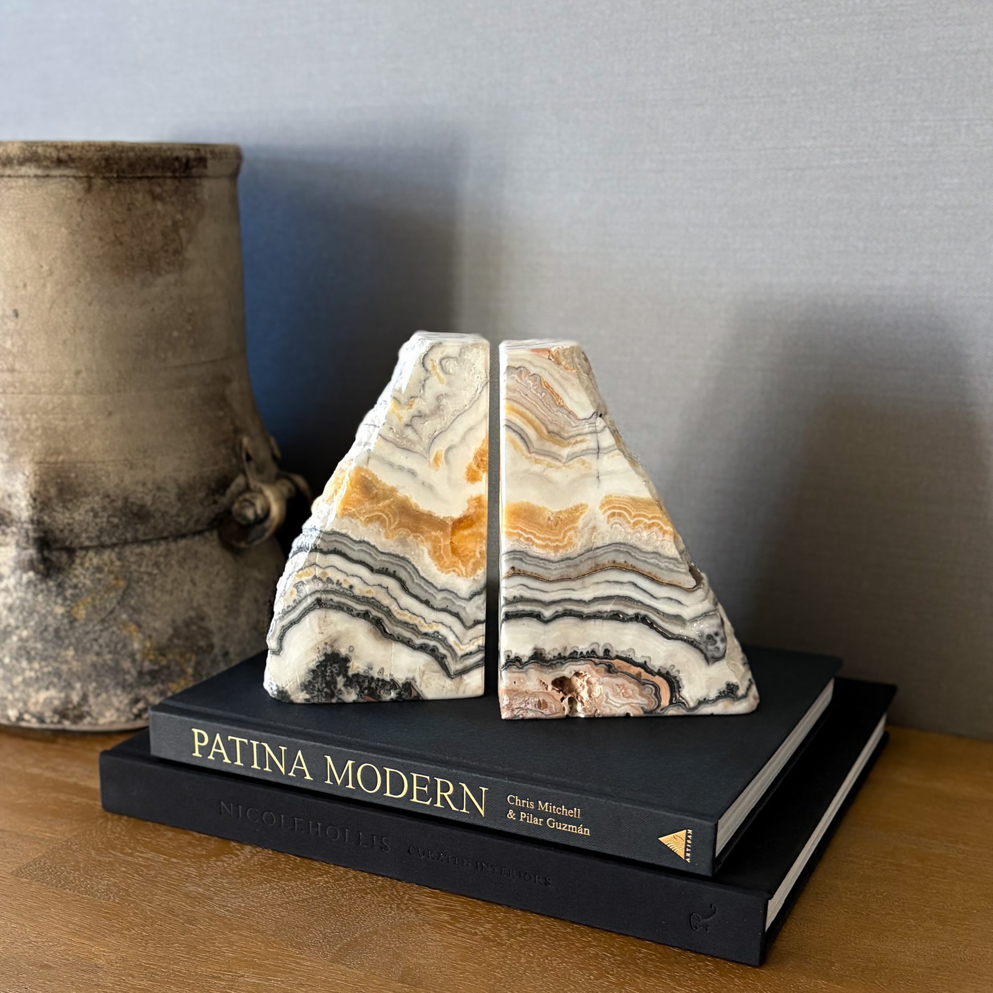 Polished zebra calcite bookends with layered black and beige veining