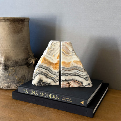 Polished zebra calcite bookends with layered black and beige veining