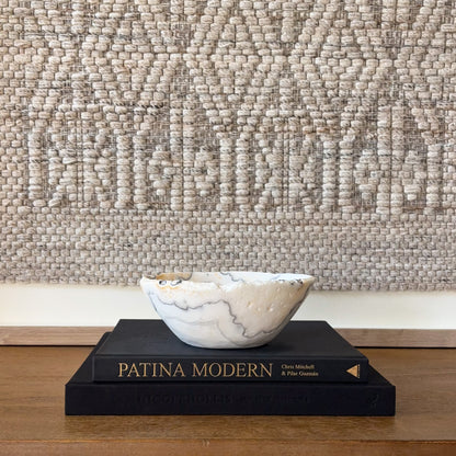Hand-carved zebra calcite bowl featuring striking black and white striped crystal pattern