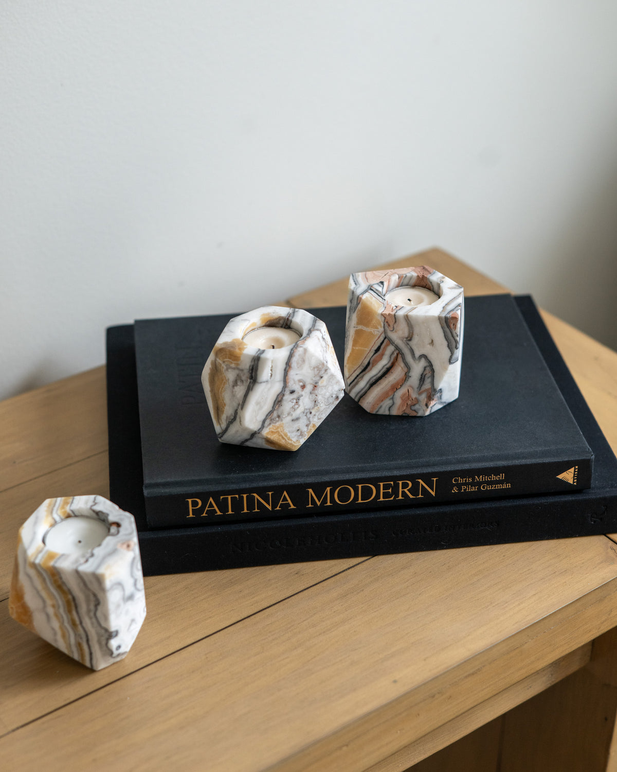 Hand-carved zebra calcite candle holders in varied cream, peach, brown and grey tones