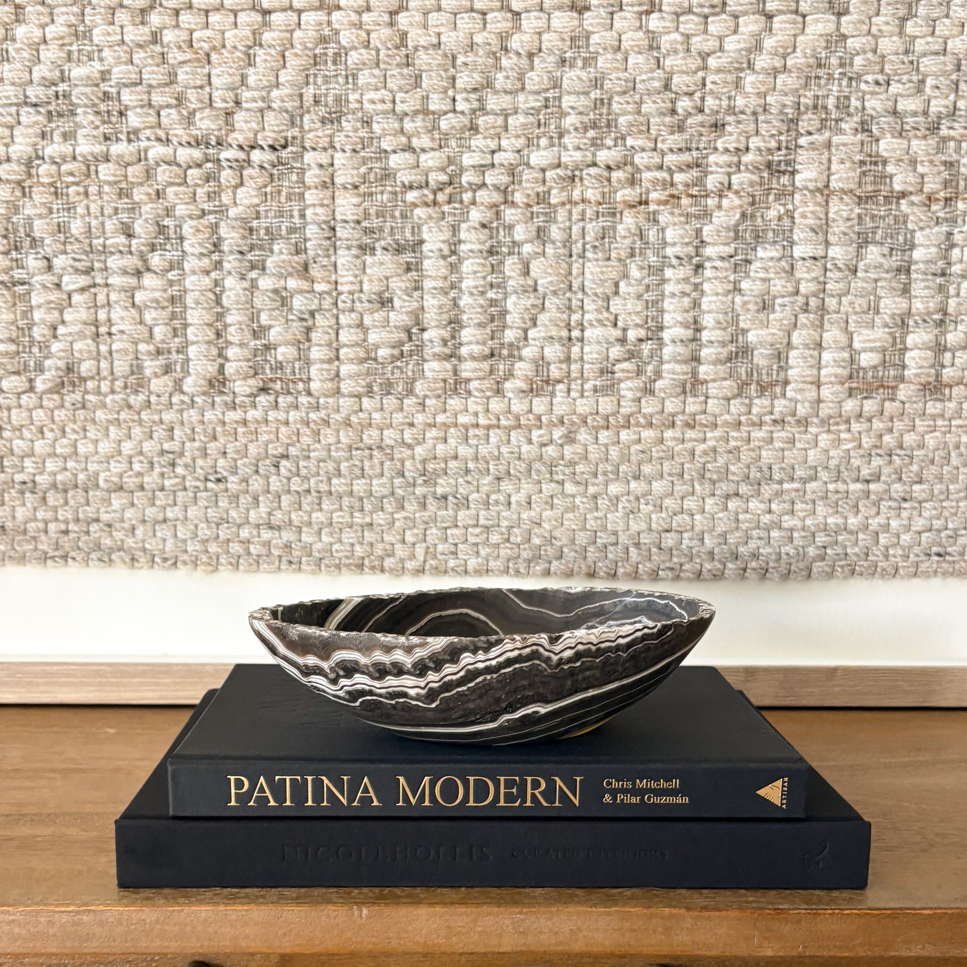 Small hand carved zebra onyx bowl featuring dramatic black and white banding, polished natural stone decorative bowl