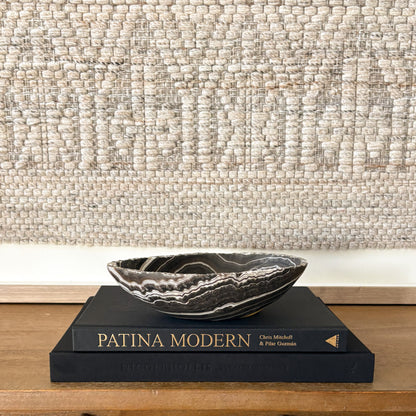 Small hand carved zebra onyx bowl featuring dramatic black and white banding, polished natural stone decorative bowl