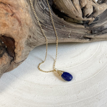 Gold pendant necklace featuring lapis lazuli