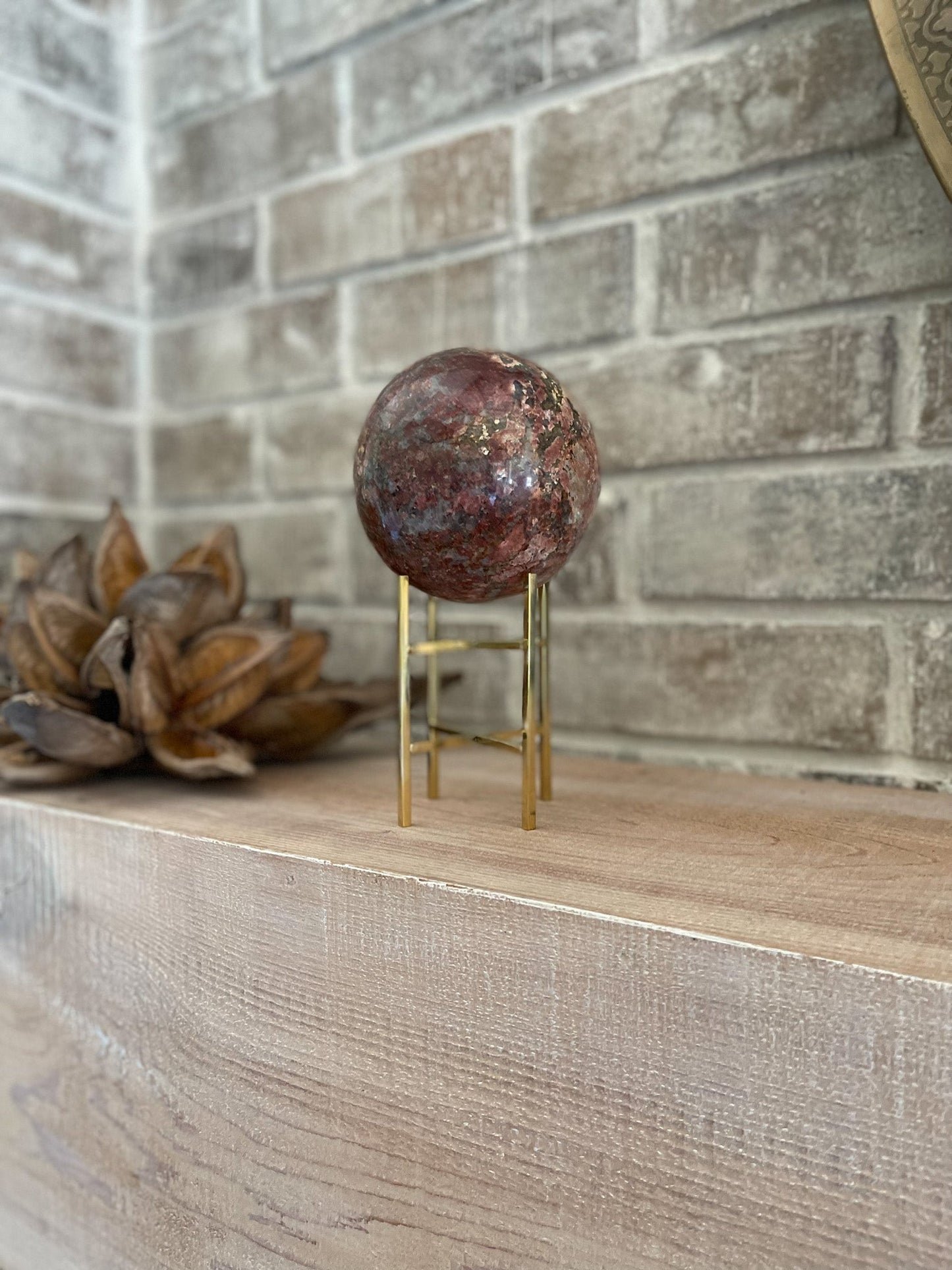 madagascar red opal crystal ball on gold stand