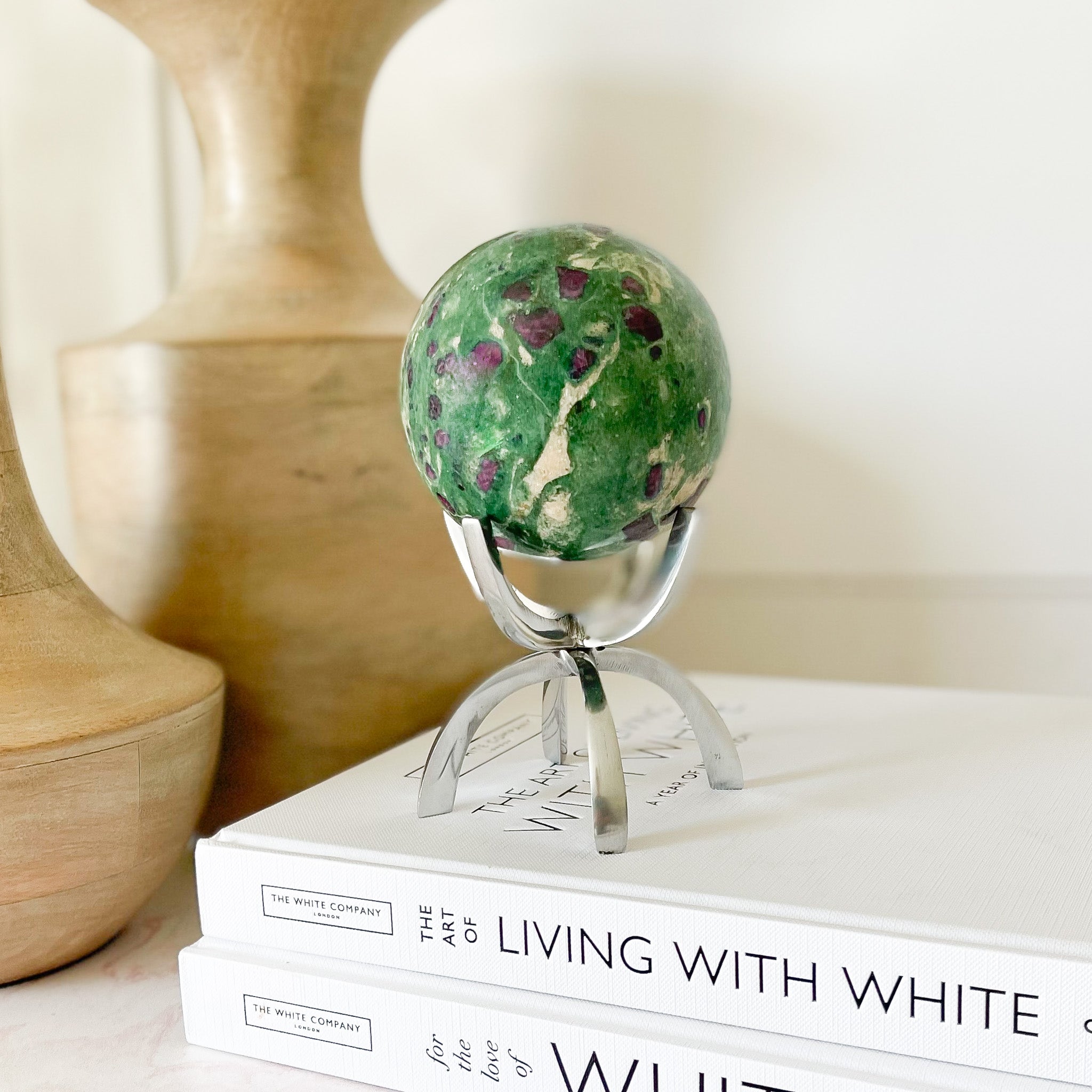 ruby fuchsite sphere on silver stand, meditation stone