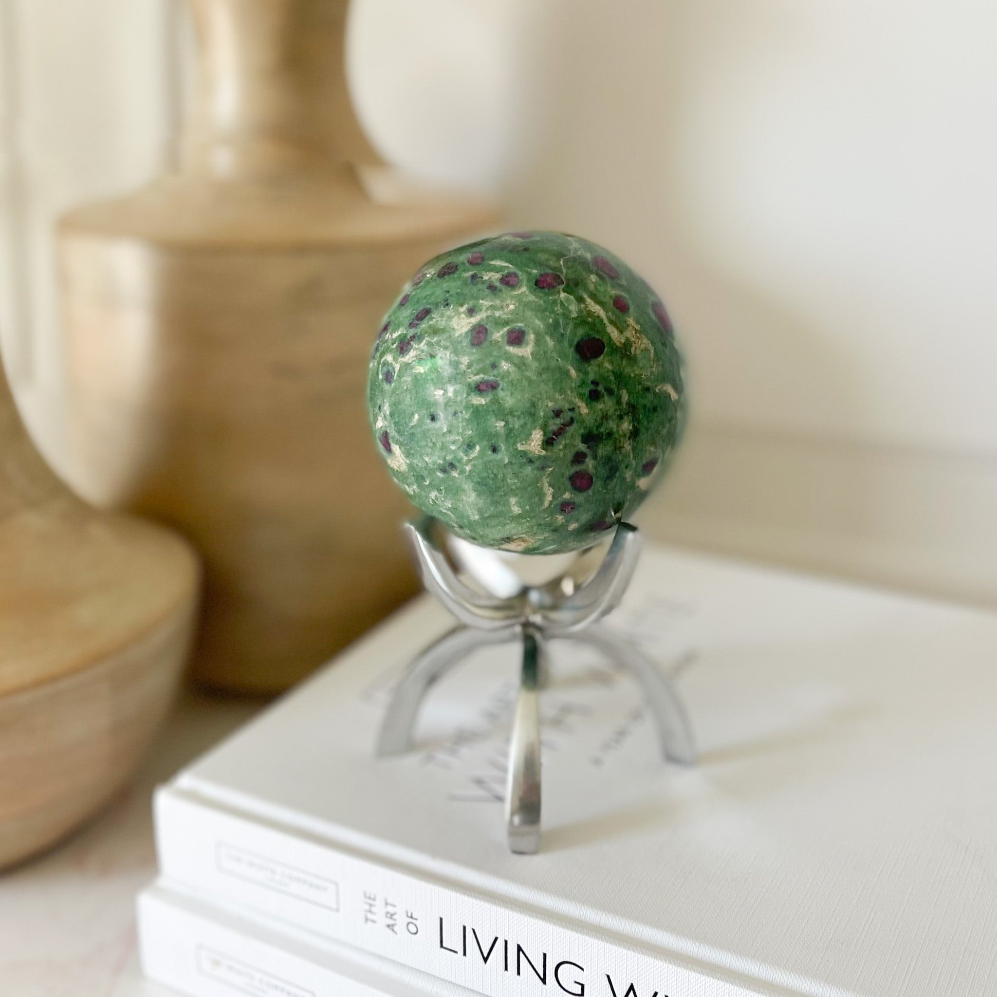 ruby fuchsite sphere on silver stand, bookshelf decor