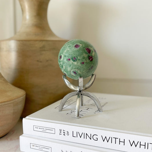ruby fuchsite sphere on silver claw stand